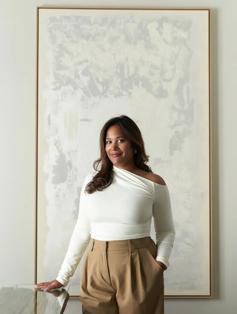 About Luxmi With Painting Behind Her